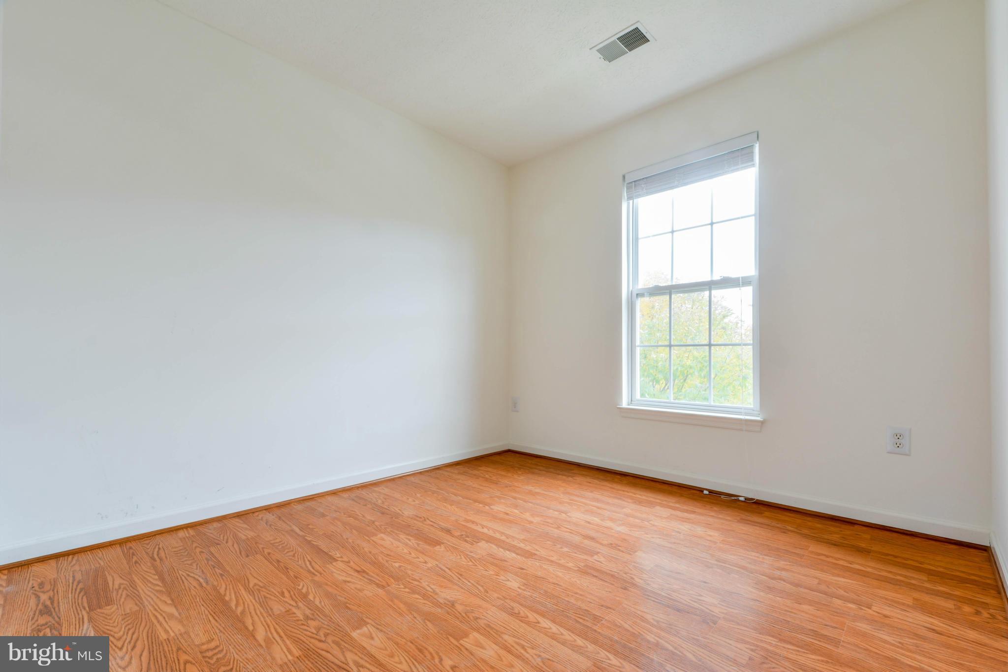 1447 Pangbourne Way Hanover, MD 21076 - Photo 25 of 30 an empty room with wooden floor and windows