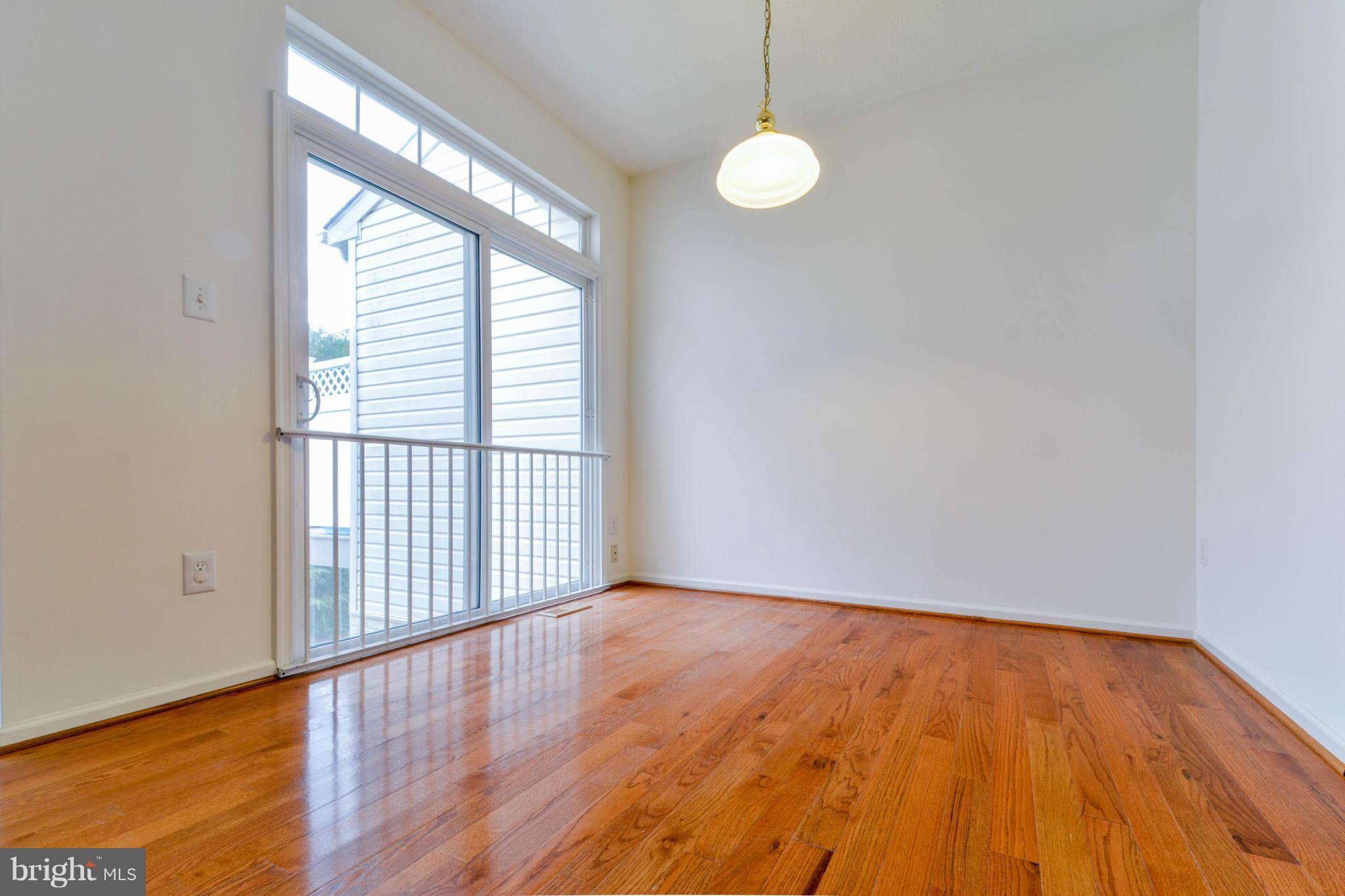 1447 Pangbourne Way Hanover, MD 21076 - Photo 7 of 30 a view of empty room with wooden floor and fan