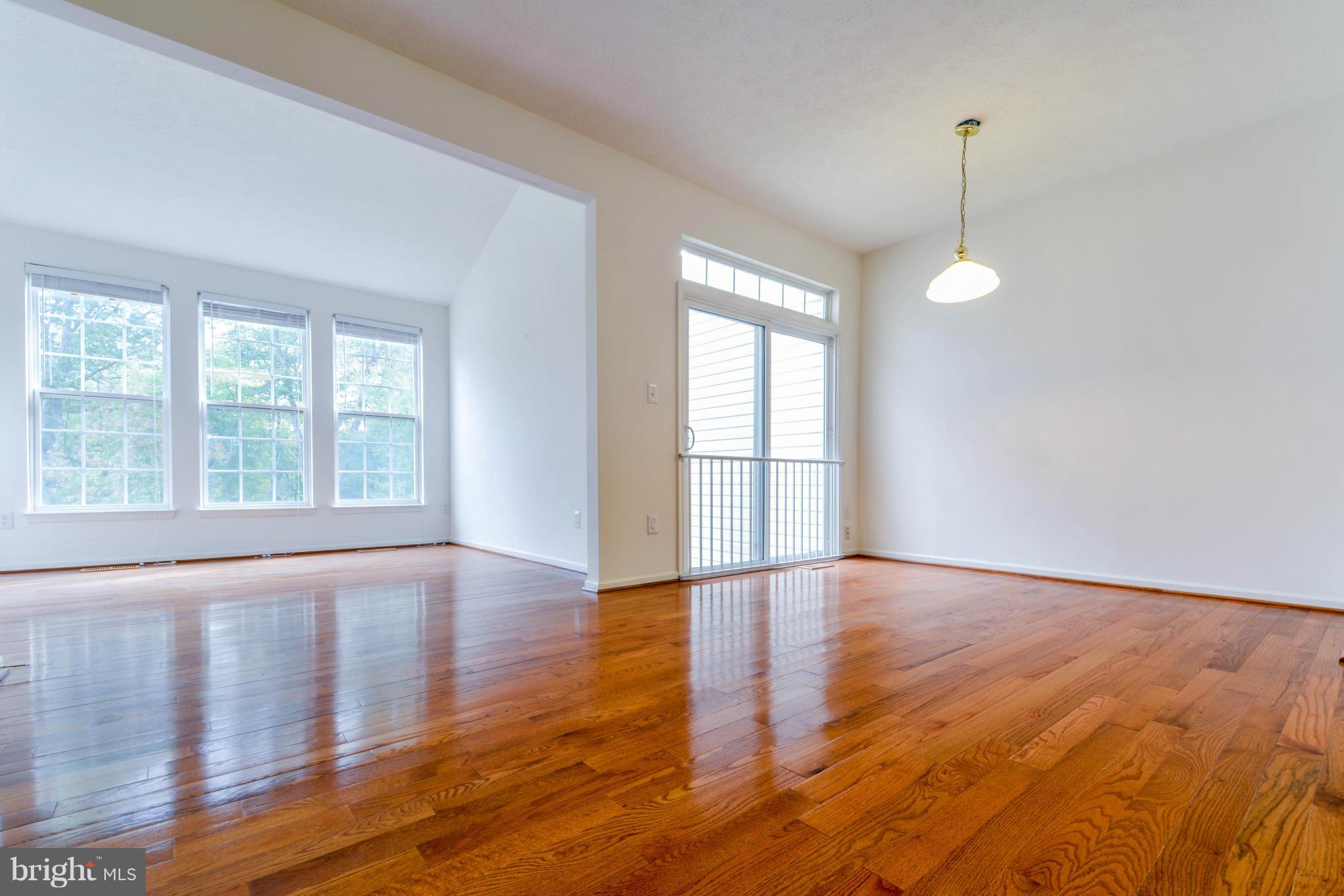 1447 Pangbourne Way Hanover, MD 21076 - Photo 8 of 30 a view of an empty room with wooden floor and a window