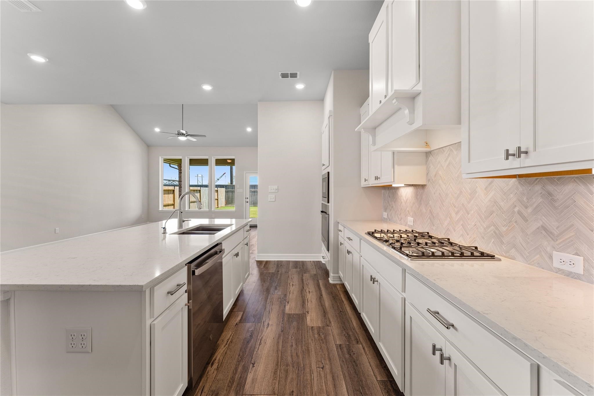 28938 Hauter Way Fulshear, TX 77441 - Photo 13 of 42 a kitchen with stainless steel appliances granite countertop a sink stove and cabinets
