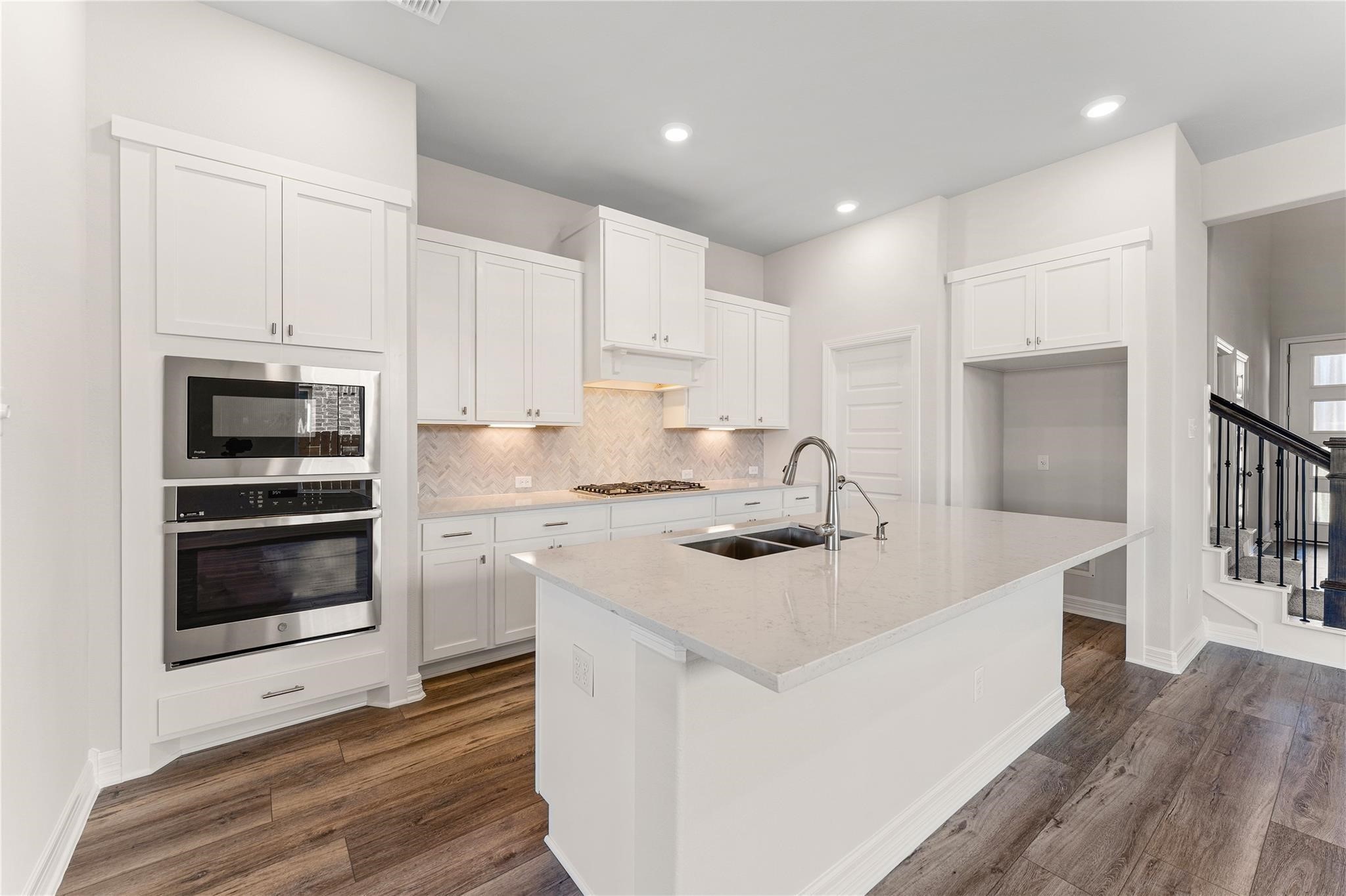 28938 Hauter Way Fulshear, TX 77441 - Photo 15 of 42 a kitchen with white cabinets appliances and sink