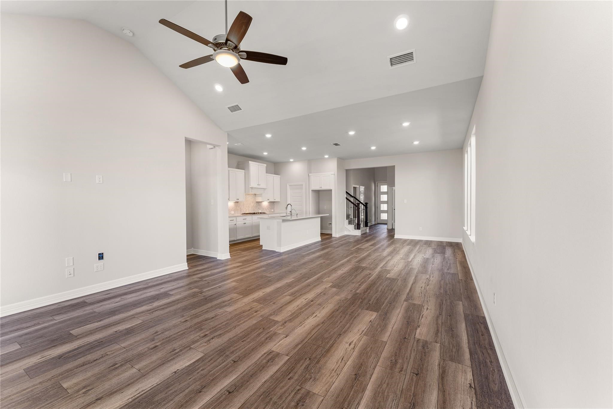 28938 Hauter Way Fulshear, TX 77441 - Photo 17 of 42 a view of a kitchen with a sink and dishwasher a refrigerator with wooden floor