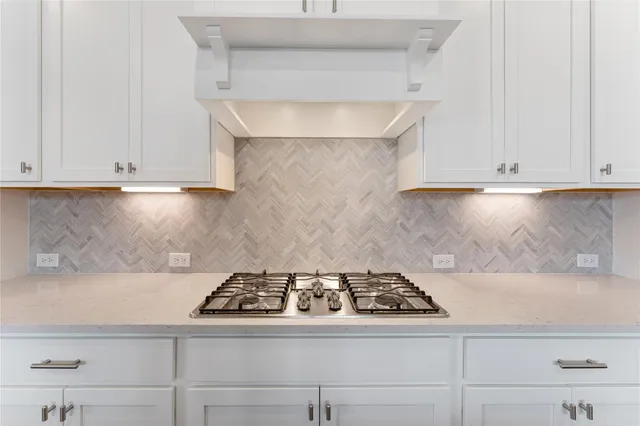 a stove top oven sitting inside of a kitchen