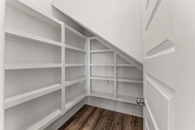 a view of a room with shelf with wooden floor
