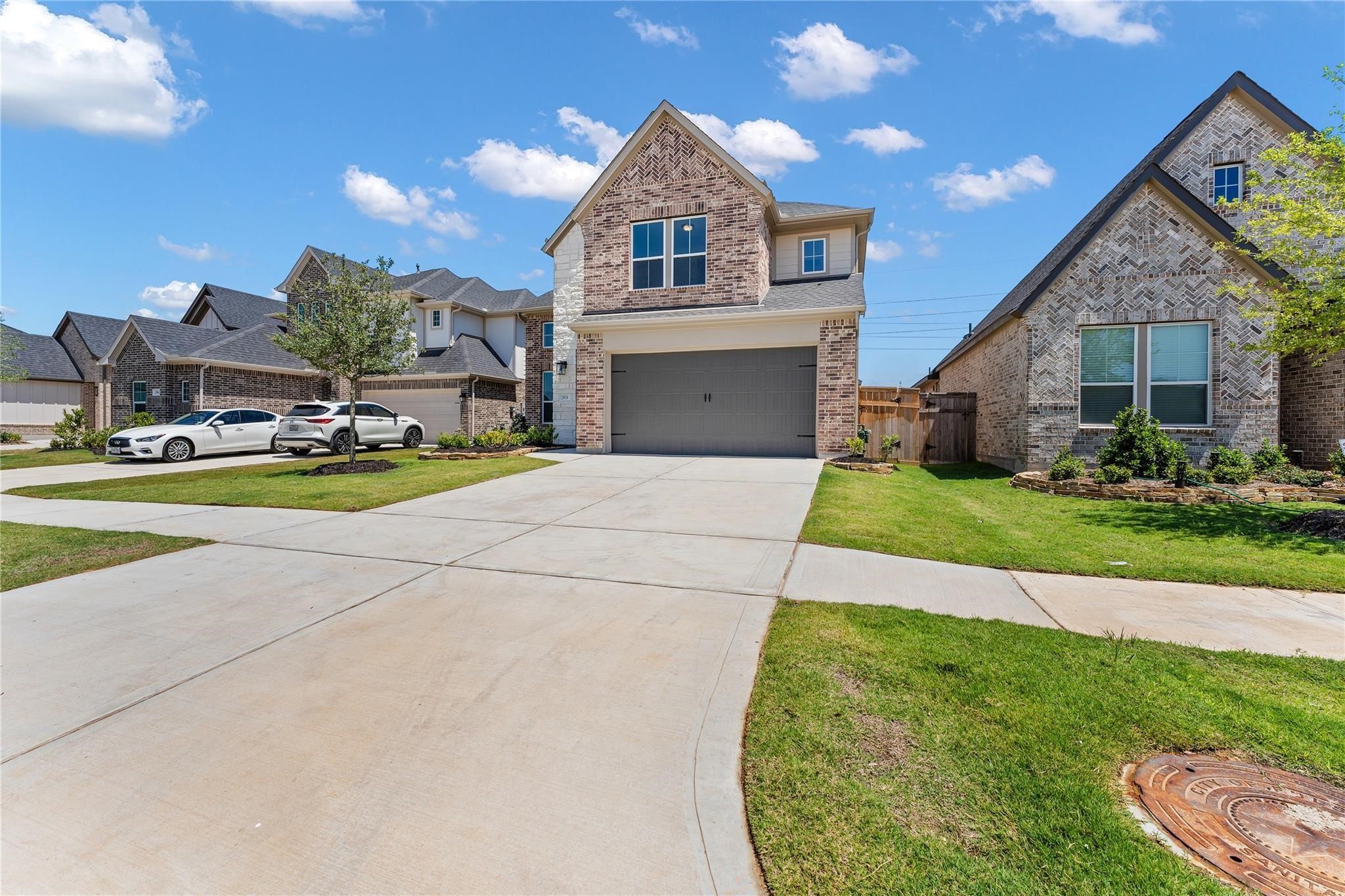 28938 Hauter Way Fulshear, TX 77441 - Photo 2 of 42 a front view of a house with a yard and potted plants