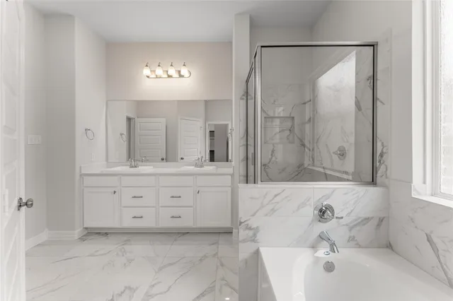 a bathroom with a bathtub shower sink and mirror