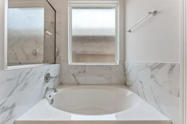 a bathroom with a bathtub and shower