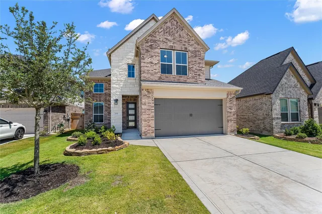 a front view of a house with a yard and porch