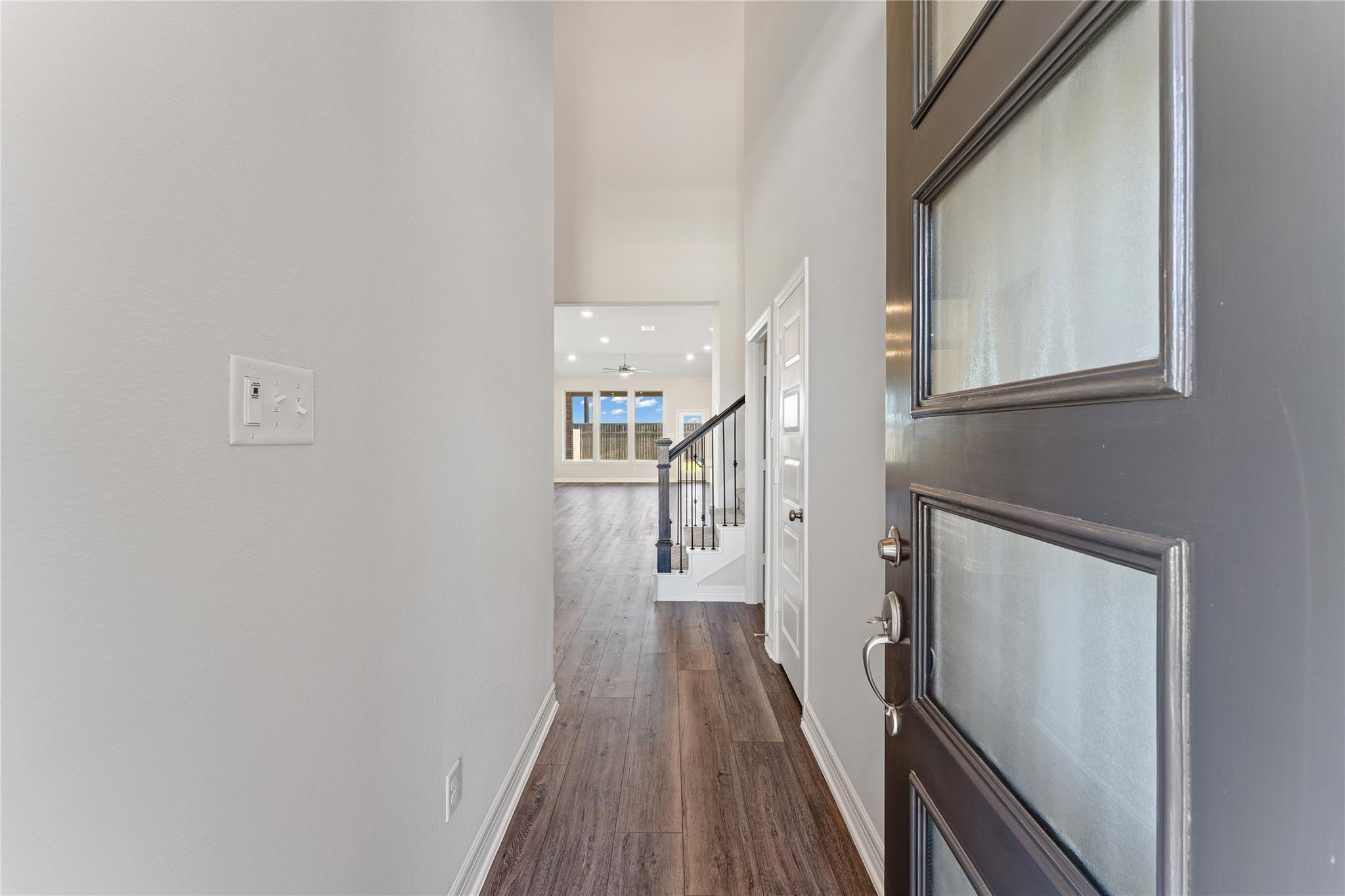 28938 Hauter Way Fulshear, TX 77441 - Photo 4 of 42 a view of a hallway with wooden floor and staircase