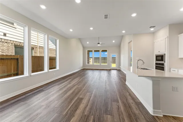 a view of kitchen with a sink and wooden floor
