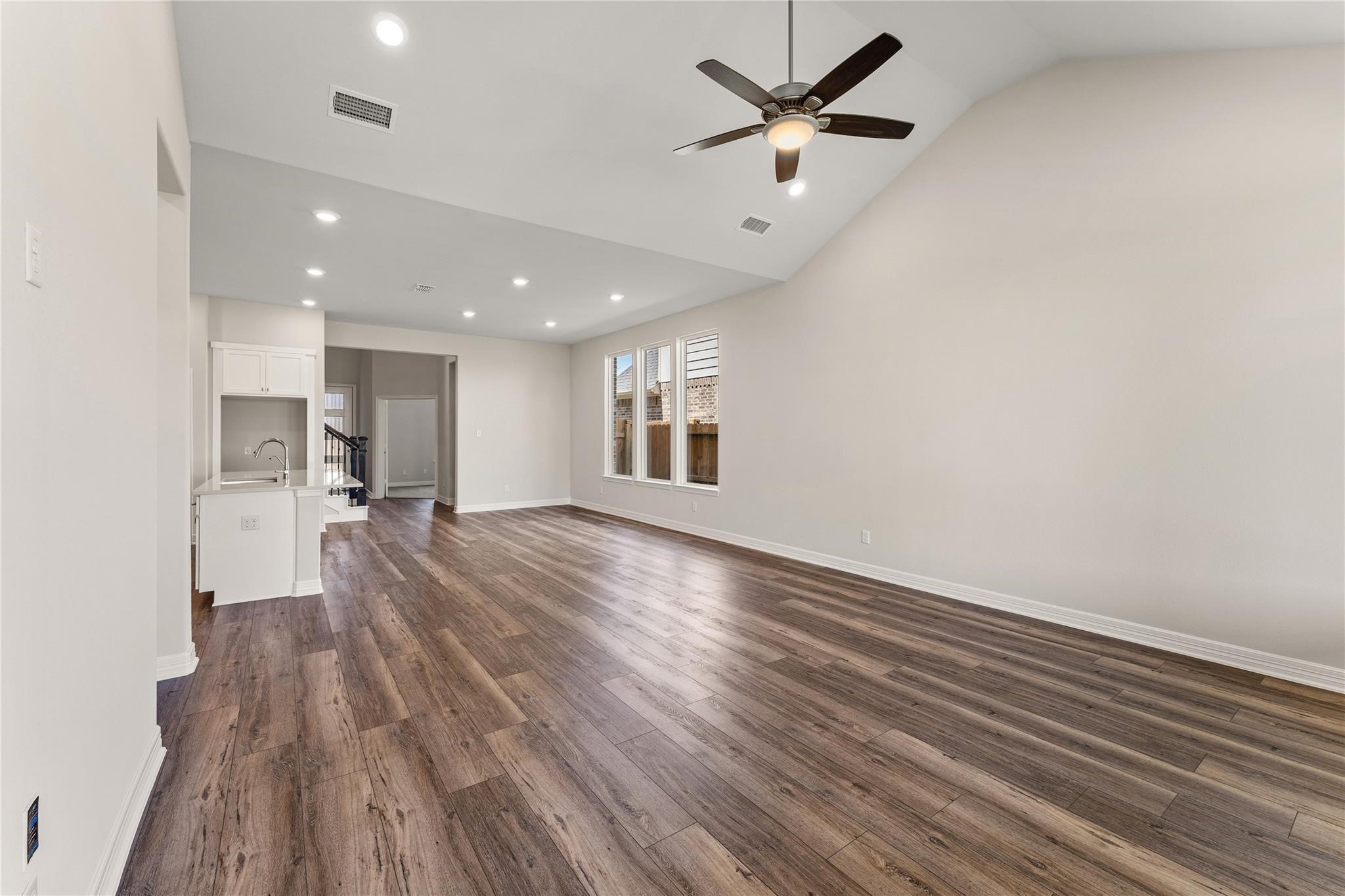 28938 Hauter Way Fulshear, TX 77441 - Photo 10 of 42 a view of a room with wooden floor and a ceiling fan