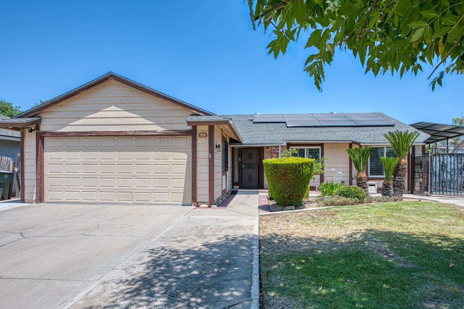 a front view of a house with yard and glass windows