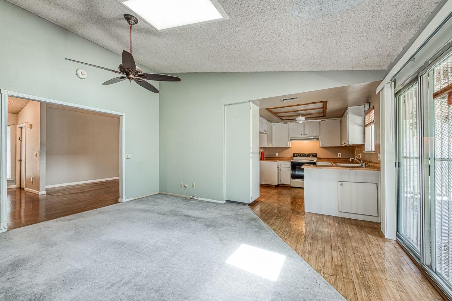 491 West Indianapolis Avenue Clovis, CA 93612 - Photo 7 of 32 a view of a kitchen with refrigerator and wooden floor
