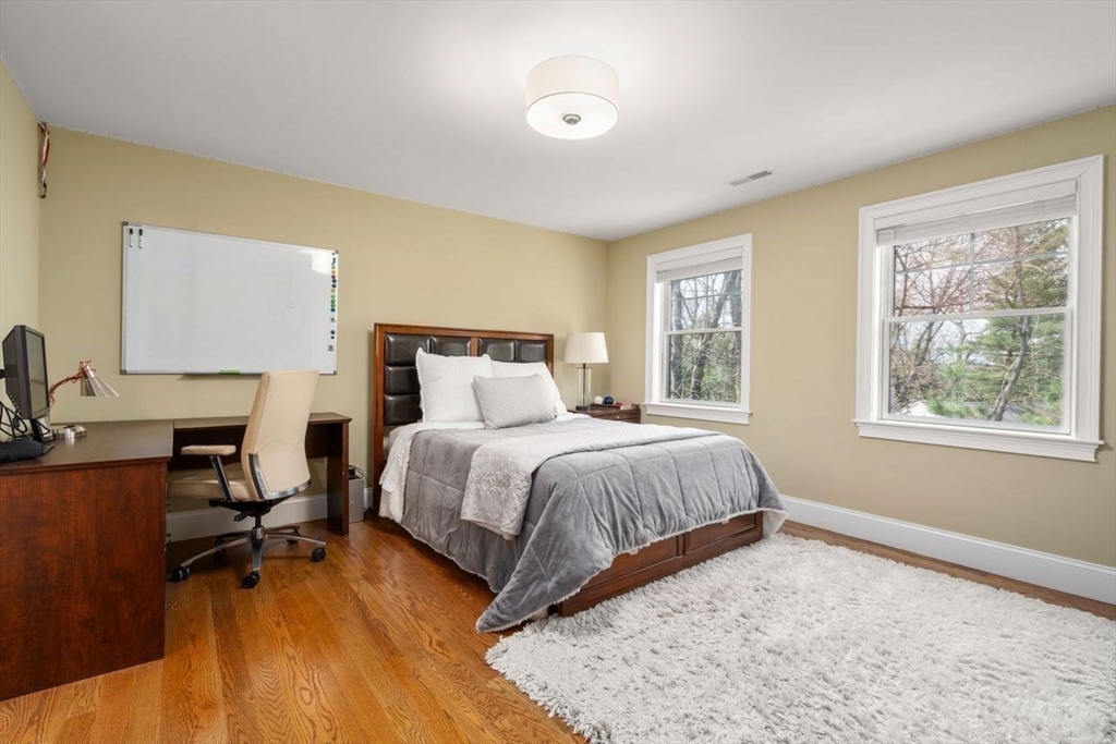 56 Blossomcrest Road Lexington, MA 02421 - Photo 20 of 29 a bedroom with a bed and wooden floor
