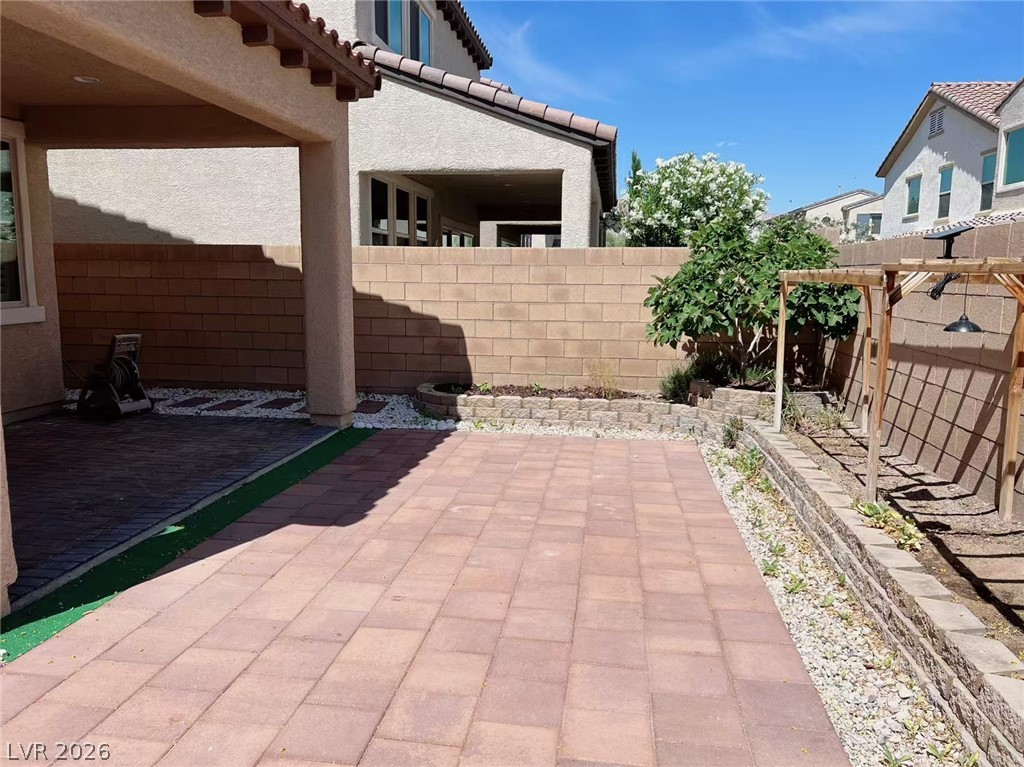 146 Tree Shot Court Las Vegas, NV 89113 - Photo 17 of 18 A generously sized paved patio awaits outdoor enjoyment, bordered by raised planters.