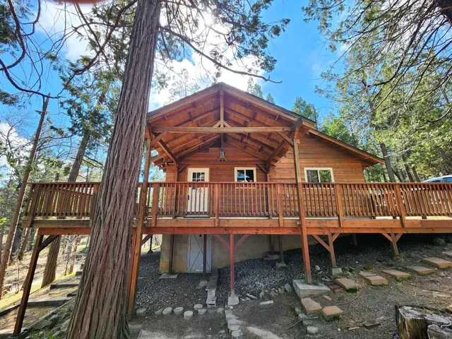 a backyard of a house with a table and chairs
