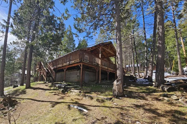 a view of a house with snow on the side of the road