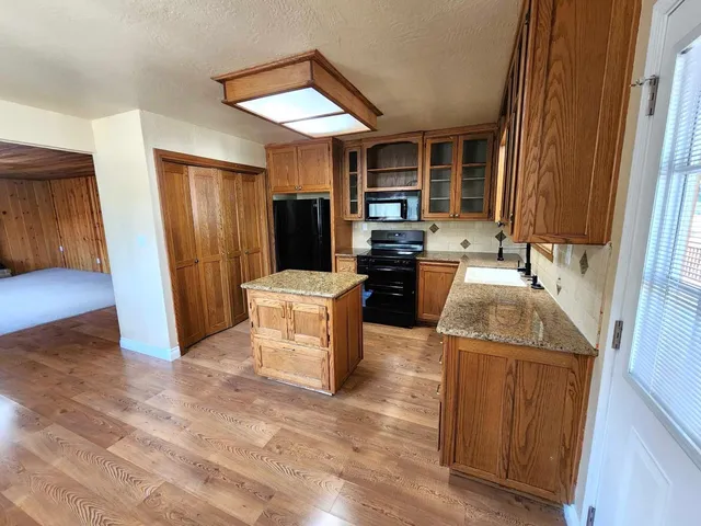 a kitchen with sink refrigerator and stove
