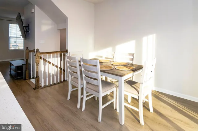 a view of a dining room with furniture and a window
