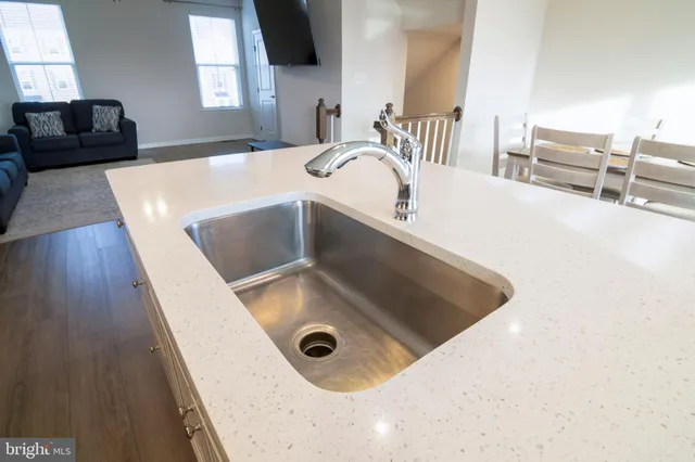 a kitchen with a sink and a stove top oven