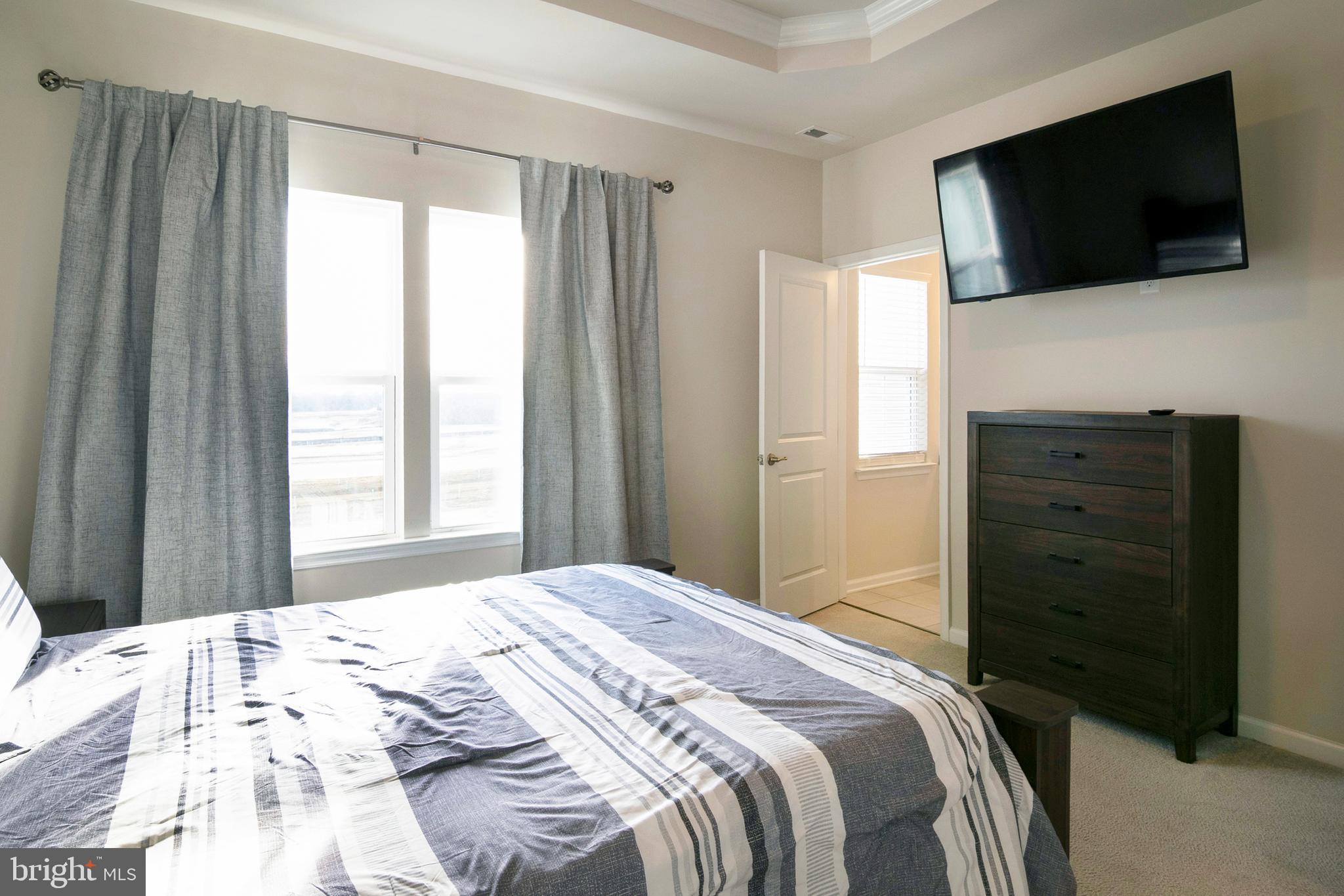 33 Roundstone Run Swedesboro, NJ 08085 - Photo 23 of 43 a bedroom with a bed and a television