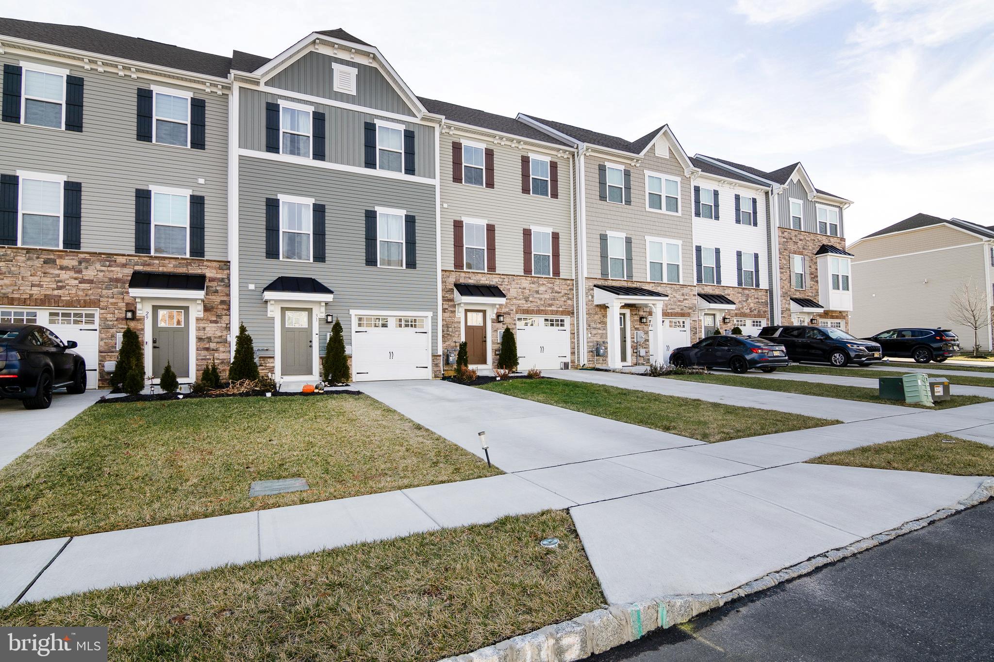 33 Roundstone Run Swedesboro, NJ 08085 - Photo 3 of 43 a view of a white house with a yard and plants