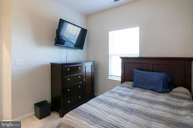 a bedroom with a bed and a television
