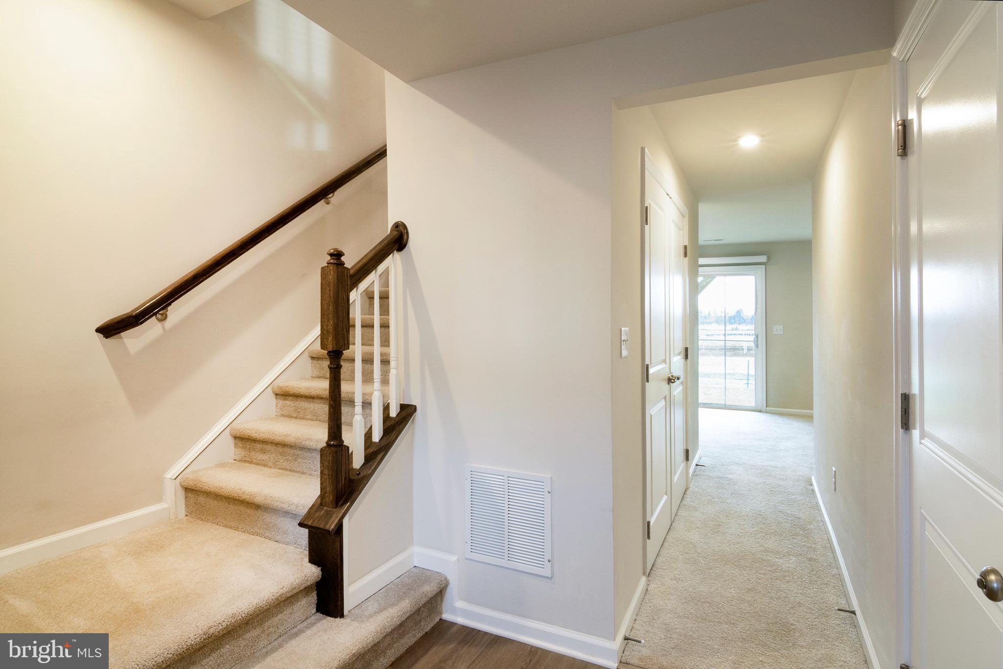 33 Roundstone Run Swedesboro, NJ 08085 - Photo 7 of 43 a view of a hallway with wooden floor and entryway