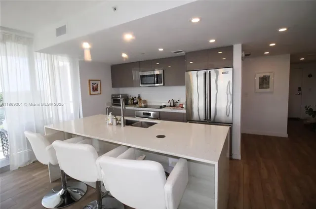 a large kitchen with a table and chairs
