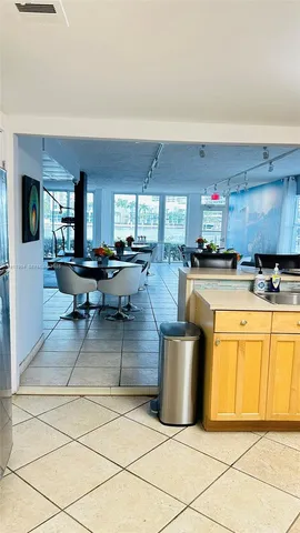 a kitchen with granite countertop a stove top oven microwave and cabinets