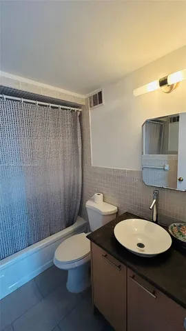 a bathroom with a toilet a sink and a mirror