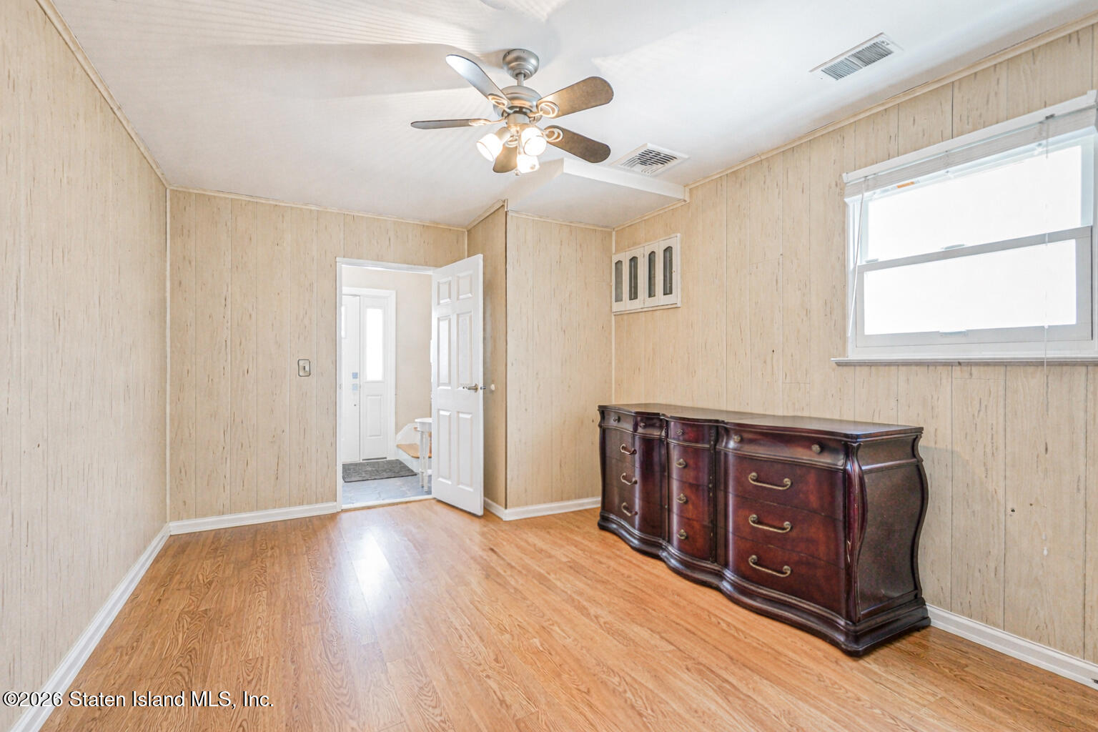 76 Berry Avenue Staten Island, NY 10312 - Photo 25 of 42 a view of an empty room with window and wooden floor