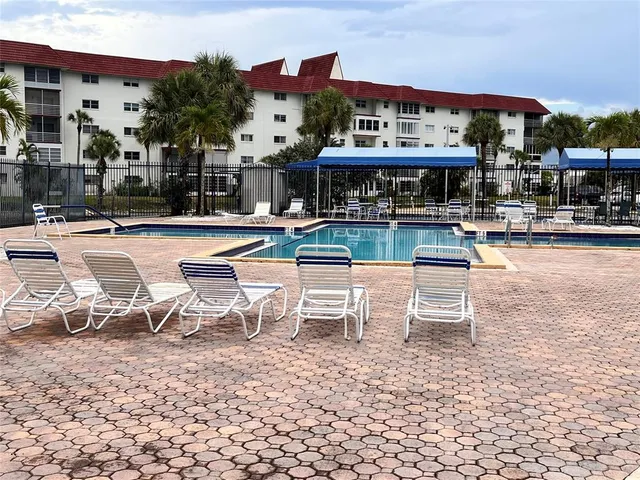 a view of a patio with a table and chairs