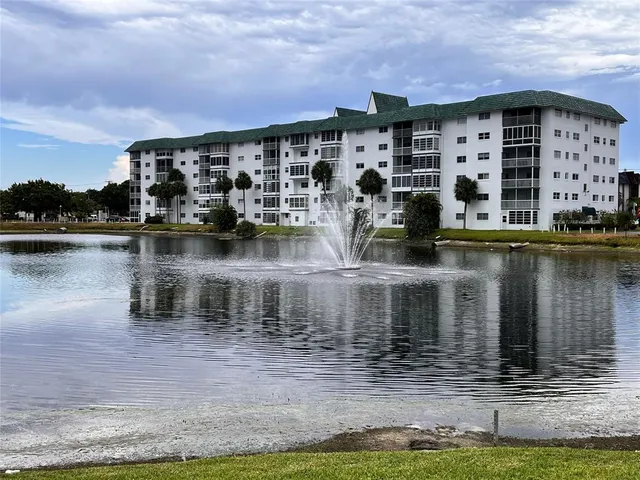 a large body of water next to a building with a lake view