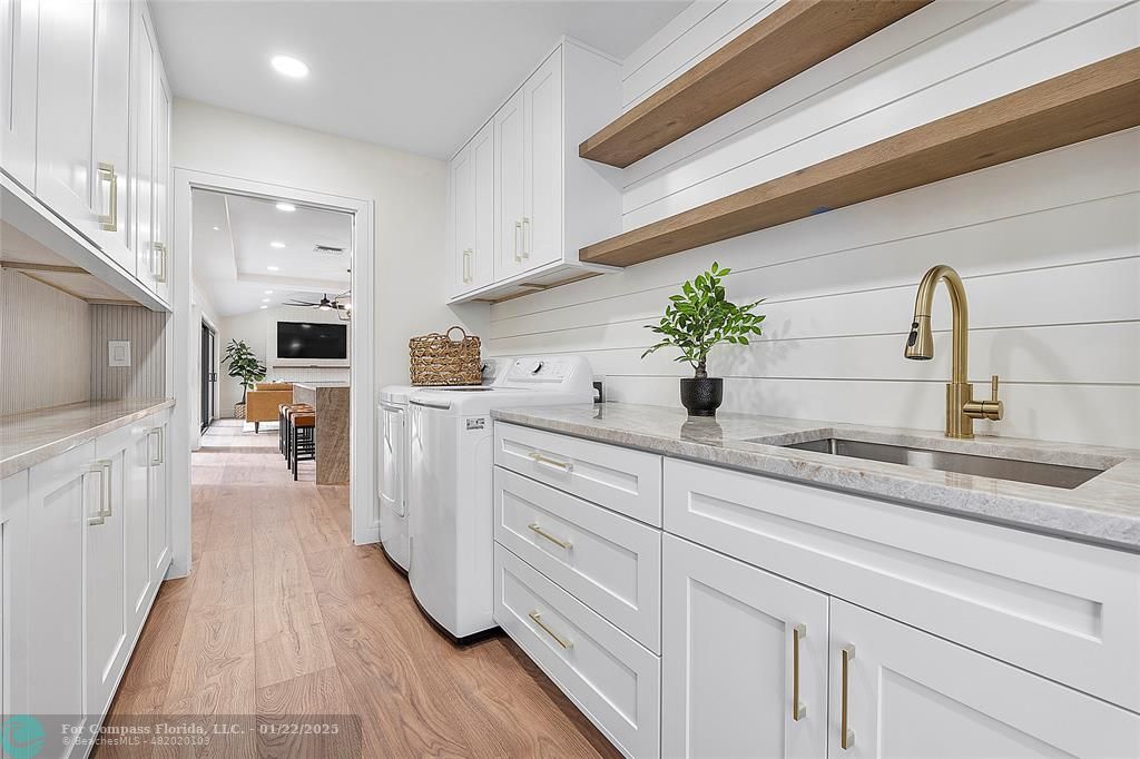 3540 Northeast 28th Avenue Lighthouse Point, FL 33064 - Photo 45 of 53 Spacious mud room with sink and storage cabinets
