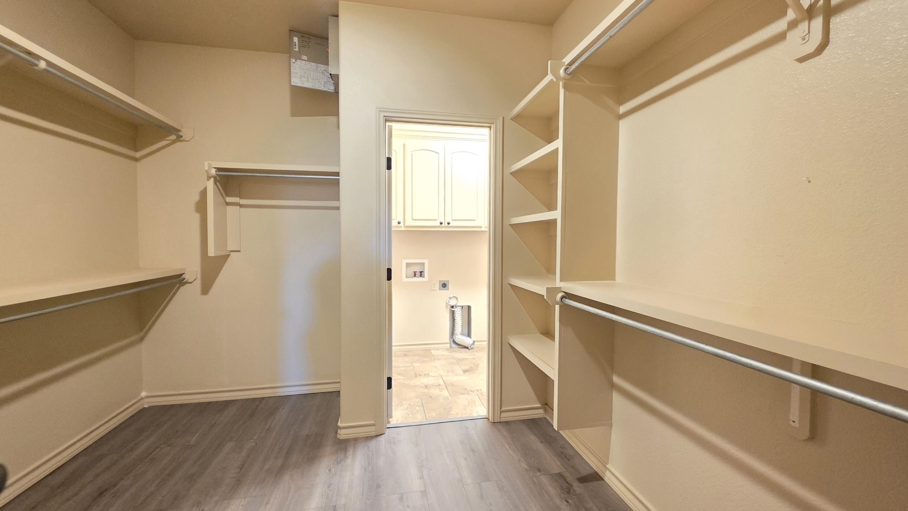 5234 Kemper Street Lubbock, TX 79416 - Photo 16 of 28 a view of walk in closet with wooden floor