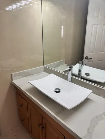 a white toilet sitting next to a bathroom sink and a tub