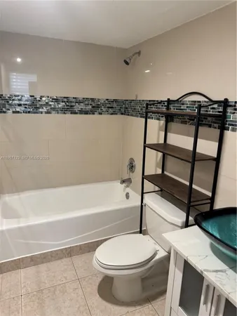 a bathroom with a toilet a sink and bathtub