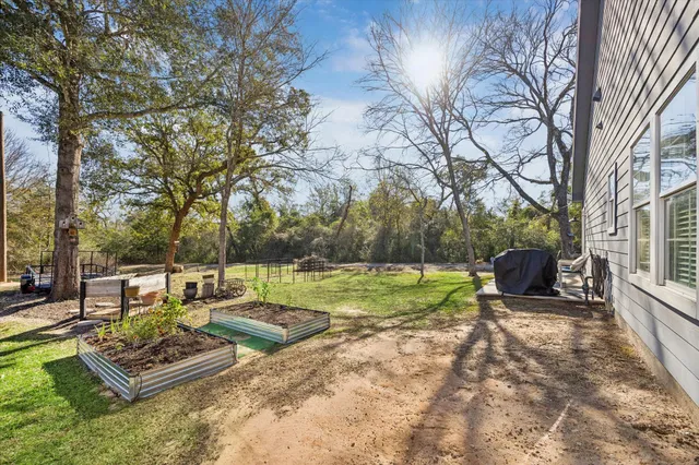 a backyard of a house with barbeque oven and outdoor seating