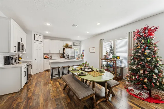 a view of a dining room with furniture and wooden floor