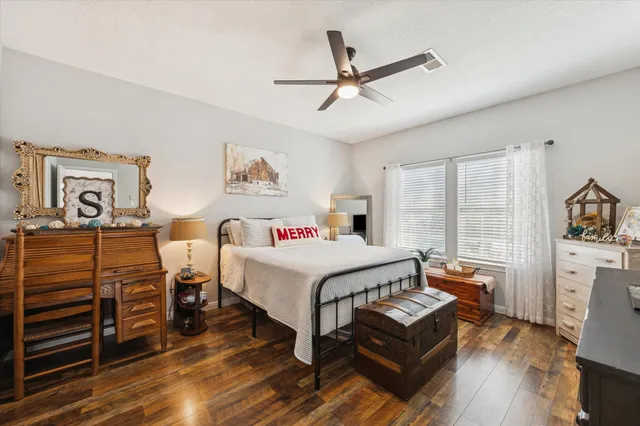 a bedroom with a bed next to a large window with the outer view
