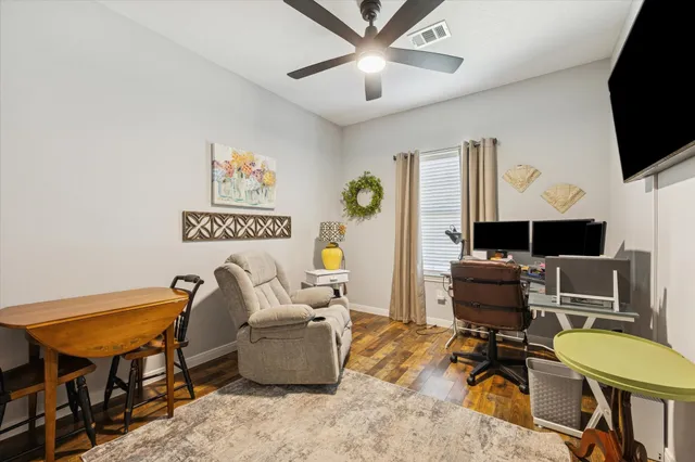 a living room with furniture a flat screen tv and a piano