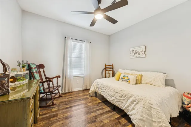 a bedroom with a bed a table and chair