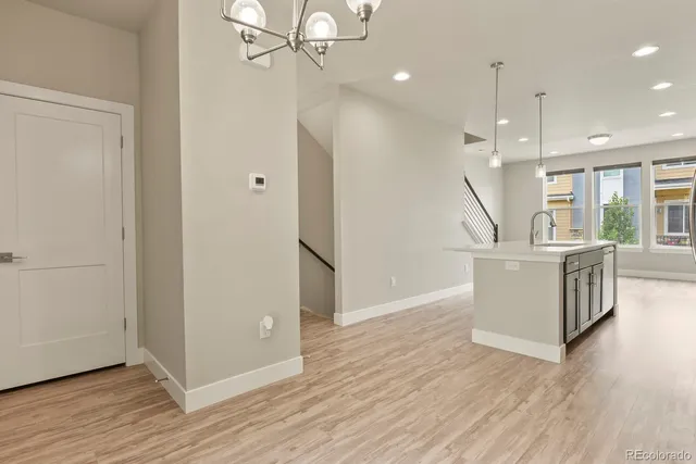 a view of a kitchen with wooden floor and electronic appliances