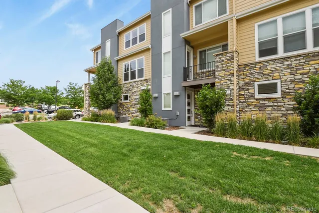 a view of a building next to a yard