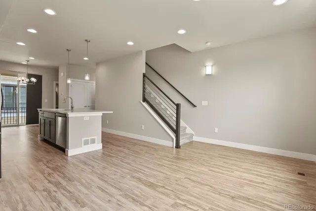 a view of kitchen and hall with wooden floor
