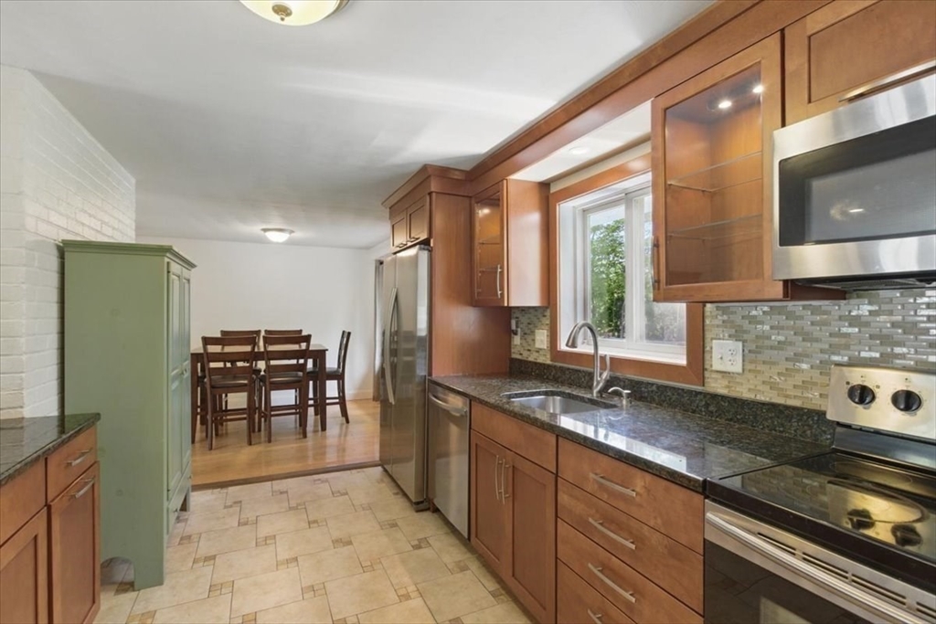15 Temi Road Beverly, MA 01915 - Photo 11 of 41 a kitchen with granite countertop a sink a stove and cabinets