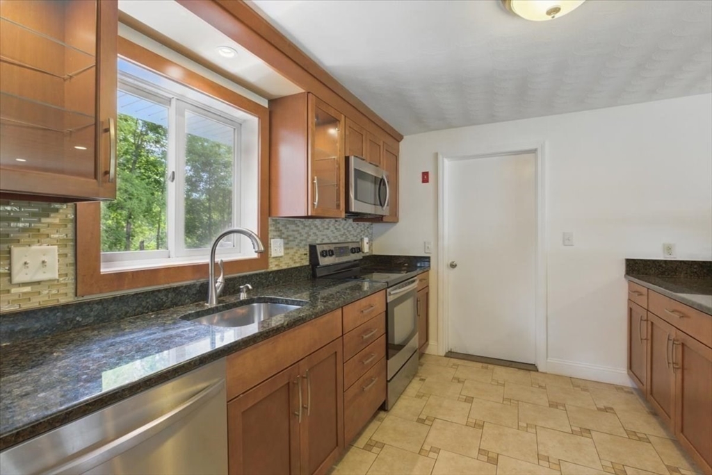15 Temi Road Beverly, MA 01915 - Photo 14 of 41 a kitchen with granite countertop a sink a counter top space and cabinets