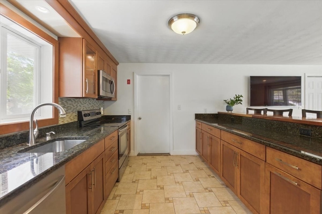 15 Temi Road Beverly, MA 01915 - Photo 15 of 41 a kitchen with stainless steel appliances granite countertop a sink stove and cabinets
