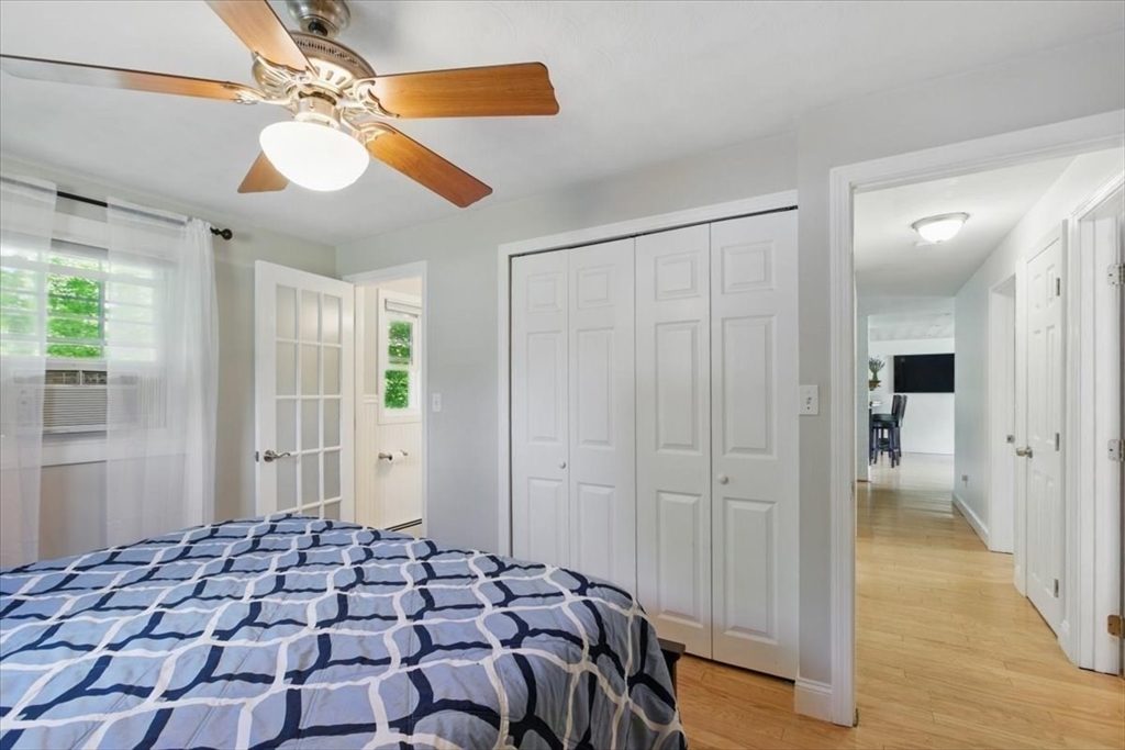 15 Temi Road Beverly, MA 01915 - Photo 29 of 41 a bedroom with a bed and a chandelier